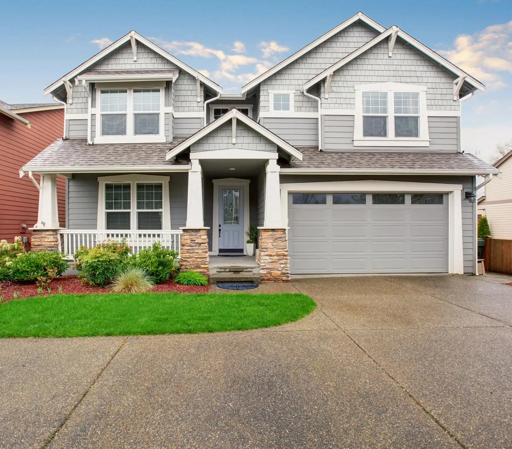 A house with a driveway and garage in front of it.