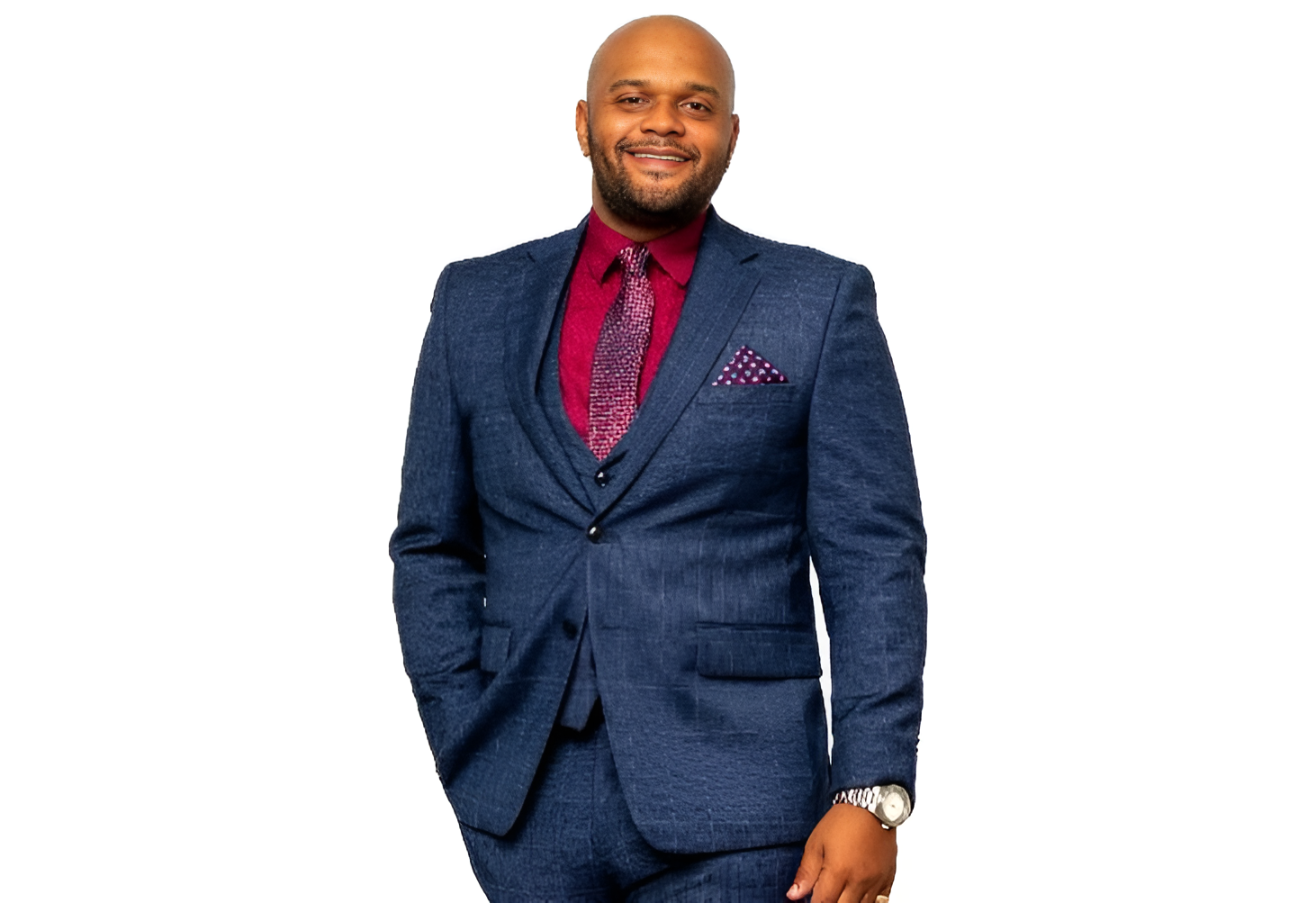 A man in a suit and tie standing next to a wall.